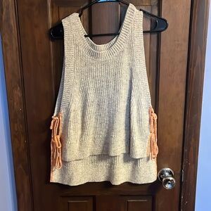 High to low knit off white tank with orange ties on the side